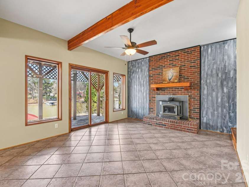 6880 Shade Tree Lane, Sherrills Ford, NC 28673.  MLS# CAR4352839, YatesRealty ID 10025. Basement recreation room has propane fireplace