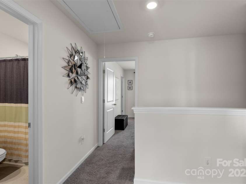64 Benedict Lane, Weaverville, NC 28787.  MLS# CAR4208936, YatesRealty ID 10032. Open hallway area on upper level with drop down attic access for added storage