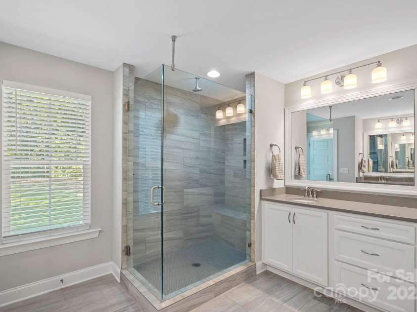 4195 Island Fox Lane, Denver, NC 28037.  MLS# CAR4243299, YatesRealty ID 10051. Beautiful walk-in tile shower with rain showerhead in primary bath.