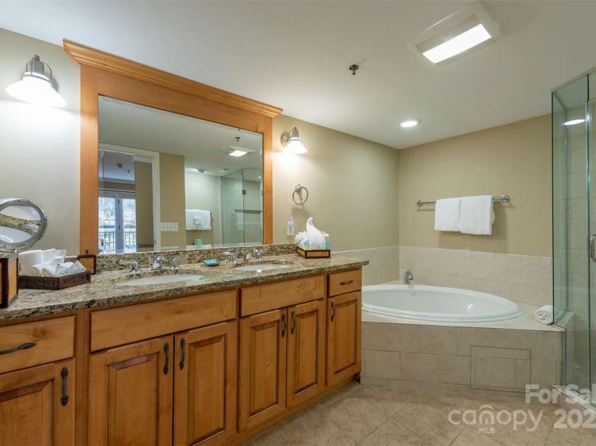 303 Bowling Park Road, Asheville, NC 28803.  MLS# CAR4202731, YatesRealty ID 10057. Primary bathroom with whirlpool soaking tub and oversized shower.