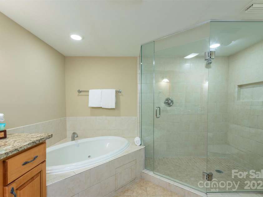 303 Bowling Park Road, Asheville, NC 28803.  MLS# CAR4202731, YatesRealty ID 10057. Primary bathroom with whirlpool soaking tub and oversized shower.