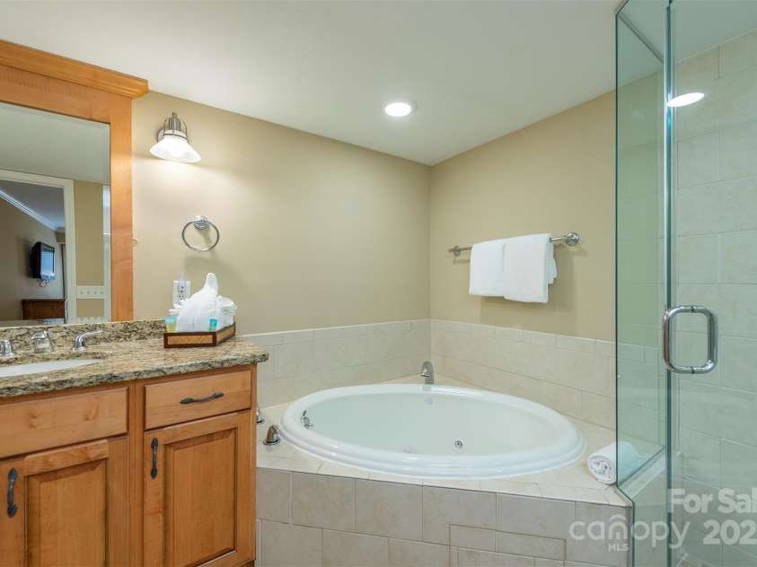 303 Bowling Park Road, Asheville, NC 28803.  MLS# CAR4202731, YatesRealty ID 10057. Primary bathroom with whirlpool soaking tub and oversized shower.