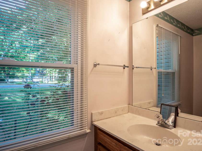 9801 Kent Village Drive, Charlotte, NC 28269.  MLS# CAR4252245, YatesRealty ID 10090. Half bath at laundry/side entry