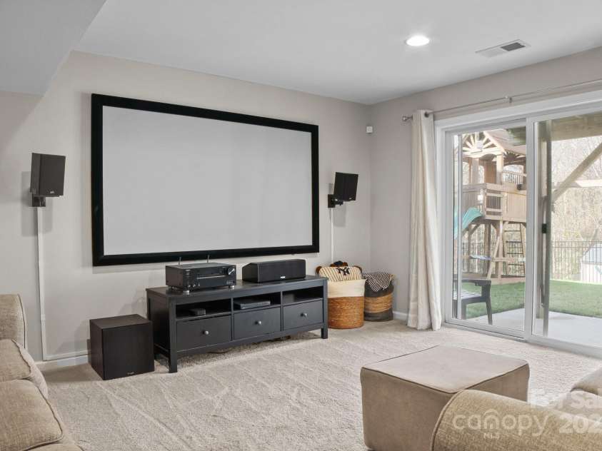 7520 Berkeley Road, Denver, NC 28037.  MLS# CAR4201191, YatesRealty ID 10093. Basement living area set up as a theater room for those cozy movie nights!