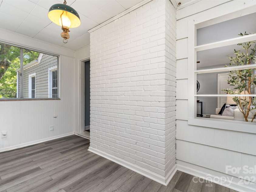 3612 The Plaza, Charlotte, NC 28205.  MLS# CAR4252499, YatesRealty ID 10099. Sunroom off the living room with new flooring.