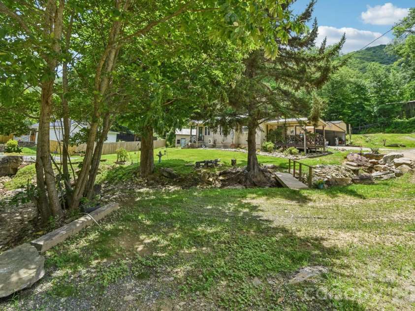19 Lockman Road, Maggie Valley, NC 28751.  MLS# CAR4270927, YatesRealty ID 10105. Creek with walkingbridge
