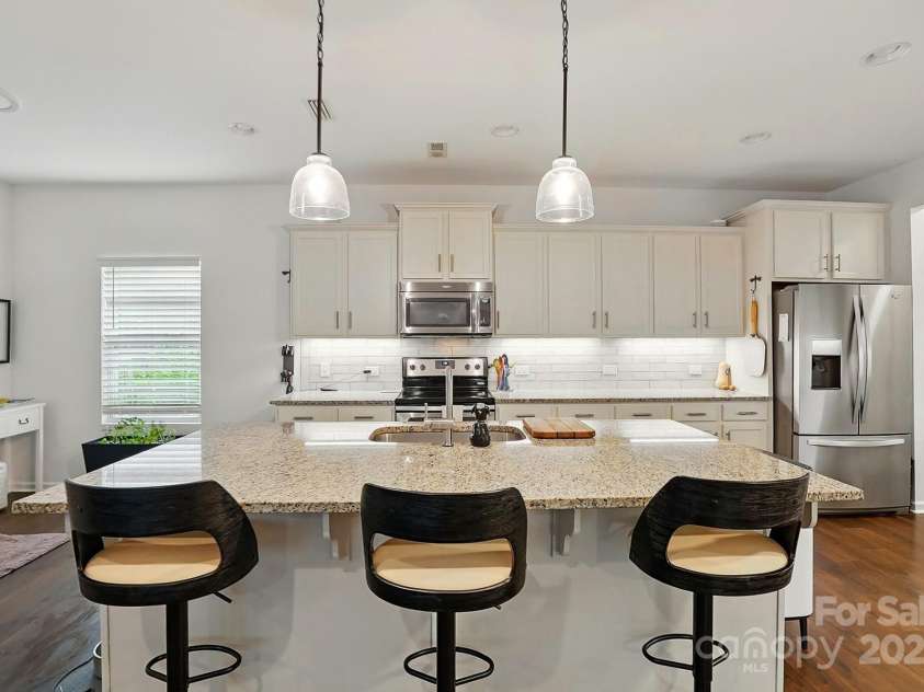 4506 Potter Road, Monroe, NC 28112.  MLS# CAR4251140, YatesRealty ID 10105. Large Kitchen with white cabinets, subway tile, granite, under cabinet lighting, walk in pantry and coffee bar!
