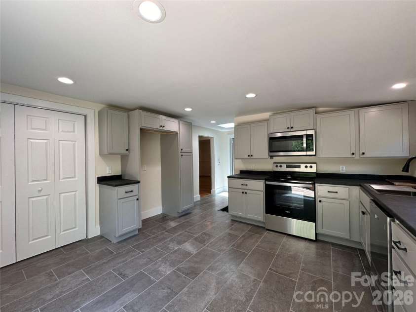 123 State Street, Asheville, NC 28806.  MLS# CAR4350606, YatesRealty ID 10115. Kitchen with laundry closet