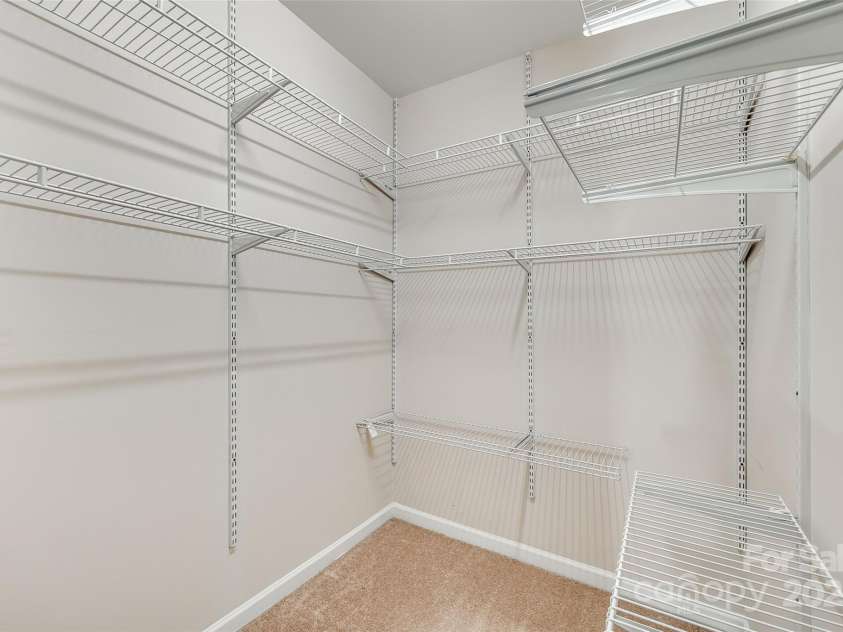 5206 Fire Water Lane, Fort Mill, SC 29707.  MLS# CAR4250029, YatesRealty ID 10118. Adjustable Closet System in Primary Closet