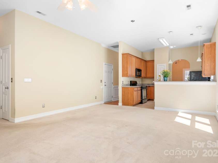 19221 Coachmans Trace, Cornelius, NC 28031.  MLS# CAR4241031, YatesRealty ID 10121. A view from the great room looking into the kitchen area.