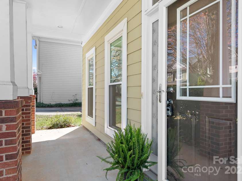 19221 Coachmans Trace, Cornelius, NC 28031.  MLS# CAR4241031, YatesRealty ID 10121. Everyone loves a front porch.  A reminder of the days when neighbors greeted each other as they walked by and sad hello.  Add a couple of chairs or a swing and a little table and you have a perfect outdoor room