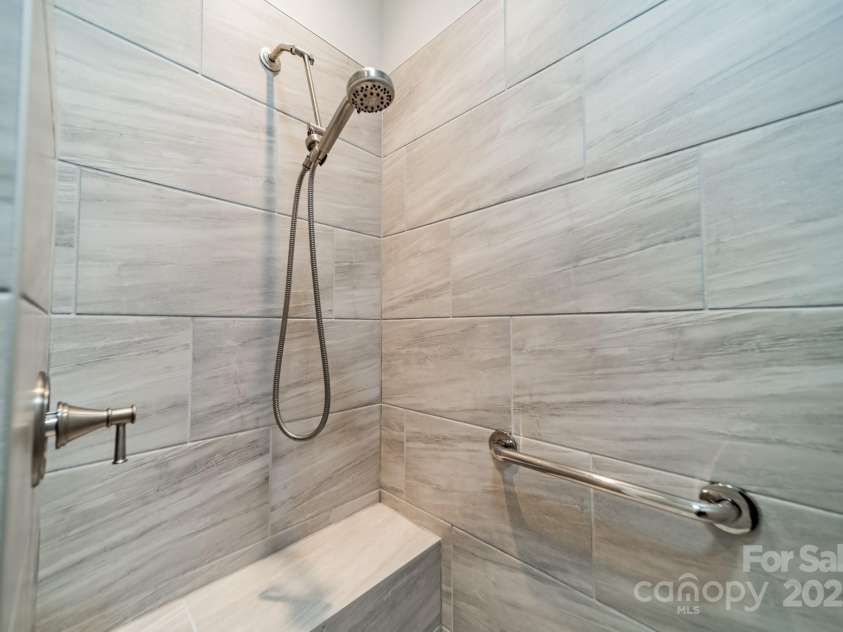 2014 Newstyle Way, Tega Cay, SC 29708.  MLS# CAR4190595, YatesRealty ID 10124. Primary Shower with Bench and Grab Bars