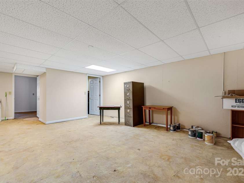77 Chestnut Street, Tryon, NC 28782.  MLS# CAR4307733, YatesRealty ID 1015. While not currently counted as living space, this could easily be converted to bring the total living area to nearly 3,000 square feet. 