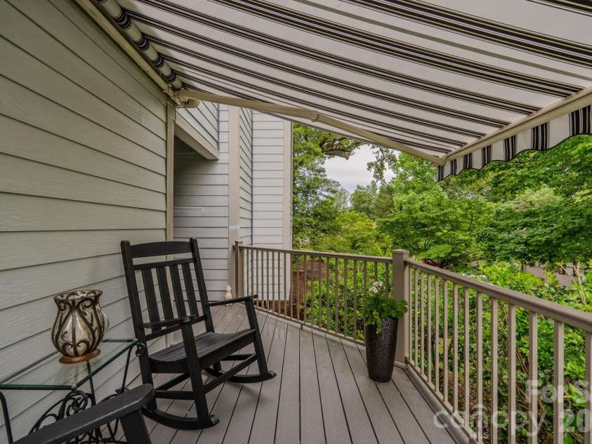 77 Chestnut Street, Tryon, NC 28782.  MLS# CAR4389953, YatesRealty ID 1015. Front door porch with retractable awning