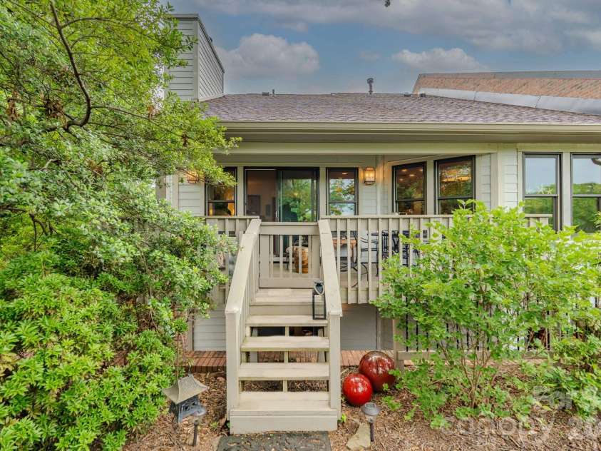 77 Chestnut Street, Tryon, NC 28782.  MLS# CAR4389953, YatesRealty ID 1015. Private deck overlooking greenspace w firepit