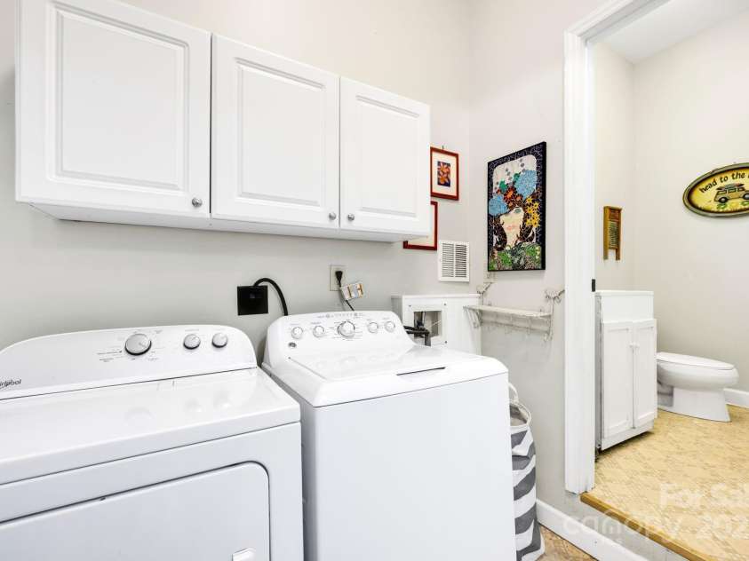 4937 Broken Saddle Lane, Charlotte, NC 28226.  MLS# CAR4244000, YatesRealty ID 10175. Garage laundry room with storage and a 1/2 bath. Perfect if you decide to put in the pool!