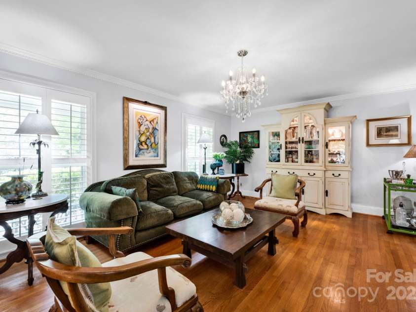 4937 Broken Saddle Lane, Charlotte, NC 28226.  MLS# CAR4244000, YatesRealty ID 10175. Living area with plantation shutters.