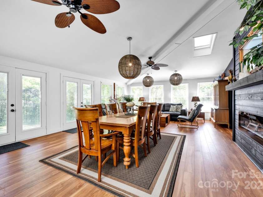 4937 Broken Saddle Lane, Charlotte, NC 28226.  MLS# CAR4244000, YatesRealty ID 10175. This sunroom is perfection! So light and bright with soaring ceilings and an electric fireplace.