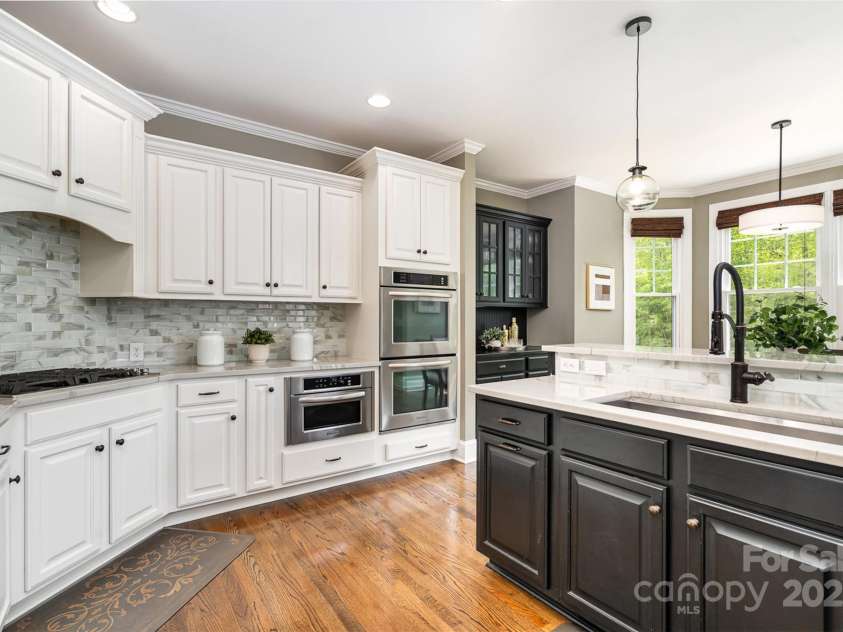 3306 Delamere Drive, Matthews, NC 28104.  MLS# CAR4247095, YatesRealty ID 10176. Kitchen- double oven, microwave, gas cooktop with downdraft venting, huge stainless steel sink