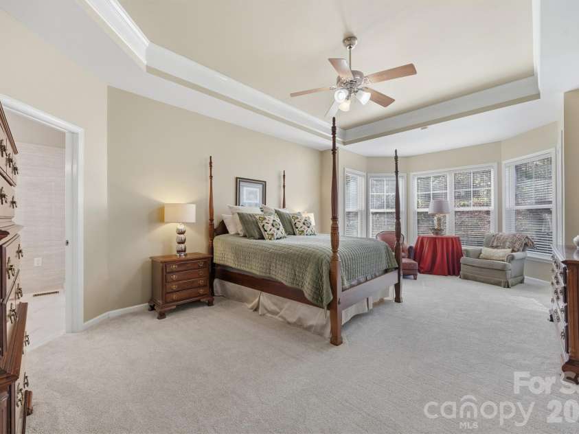 1132 Aringill Lane, Matthews, NC 28104.  MLS# CAR4361071, YatesRealty ID 10178. Expansive primary suite with a tray ceiling.