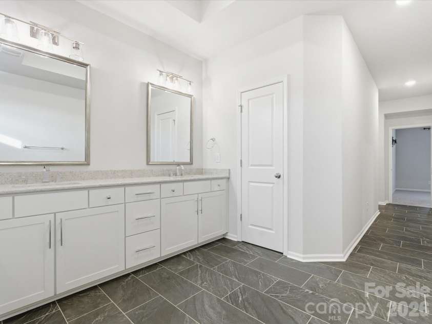 8018 Houser Street, Cornelius, NC 28031.  MLS# CAR4321846, YatesRealty ID 10235. Jack and Jill style laundry opens from the primary bathroom