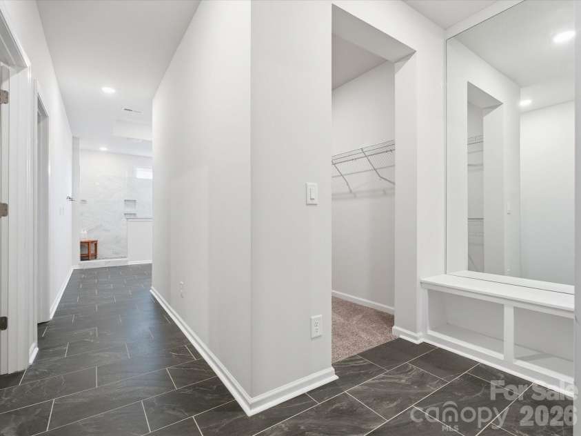 8018 Houser Street, Cornelius, NC 28031.  MLS# CAR4321846, YatesRealty ID 10235. The HALLWAY of the primary bath/closets!