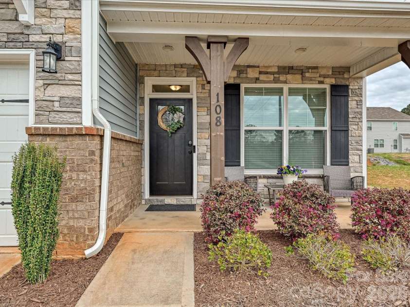 108 Old Field Road, Statesville, NC 28677.  MLS# CAR4360995, YatesRealty ID 10252. Inviting covered front entry with charming stone accents, decorative columns, and a cozy porch—perfect for welcoming guests or relaxing outdoors.