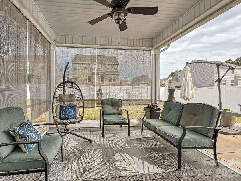 108 Old Field Road, Statesville, NC 28677.  MLS# CAR4360995, YatesRealty ID 10252. Relax on the screened-in porch featuring a ceiling fan and comfortable seating—perfect for enjoying the outdoors year-round in comfort and privacy.