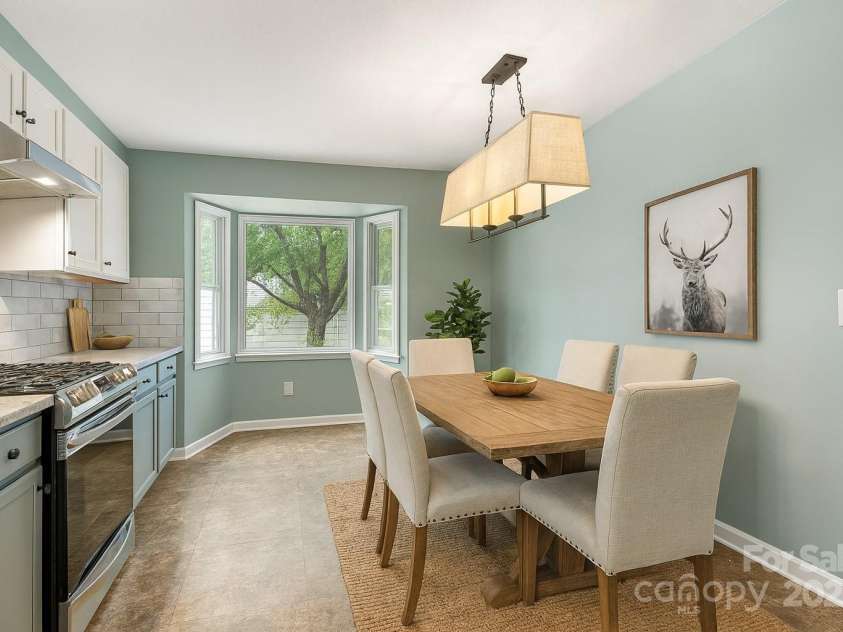 129 Exeter Court, Hendersonville, NC 28791.  MLS# CAR4299063, YatesRealty ID 10256. AI staged kitchen