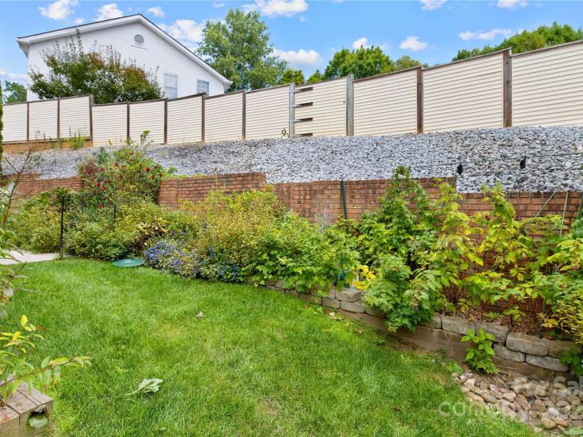 129 Exeter Court, Hendersonville, NC 28791.  MLS# CAR4299063, YatesRealty ID 10256. Back garden