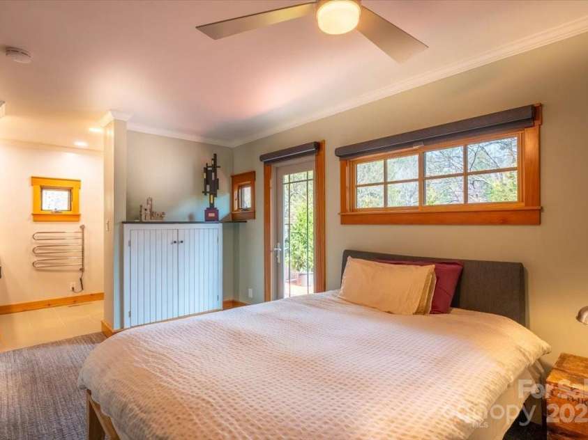 206 West Lane, Brevard, NC 28712.  MLS# CAR4226105, YatesRealty ID 10261. Primary bedroom with a private patio exit and en suite bathroom