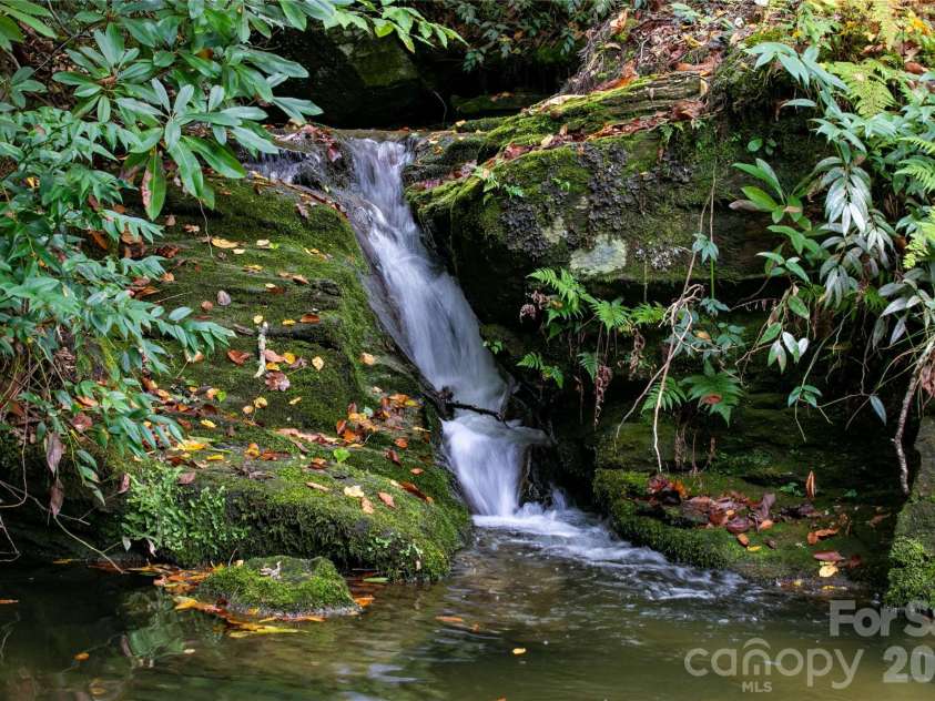 923 Ugugu Drive, Brevard, NC 28712.  MLS# CAR4307583, YatesRealty ID 10273. Enjoy this stunning waterfall from your deck.