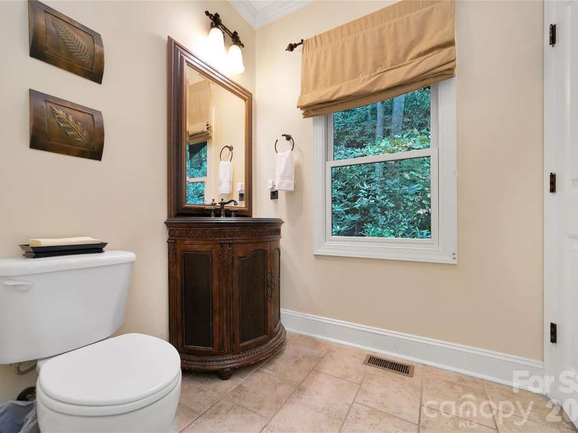 923 Ugugu Drive, Brevard, NC 28712.  MLS# CAR4307583, YatesRealty ID 10273. Half bath off kitchen