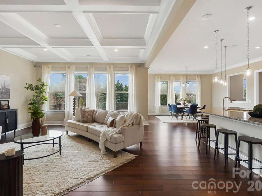 1105 Giacomo Drive, Waxhaw, NC 28173.  MLS# CAR4346410, YatesRealty ID 10275. Open and spacious great room with coffered ceilings, stunning stone fireplace, and a wall of windows. 