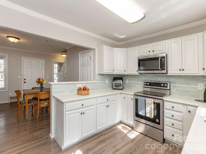 10 Aberdeen Drive, Arden, NC 28704.  MLS# CAR4344820, YatesRealty ID 10276. Beautiful updated cabinets and tile adds an update and charm to the ktichen