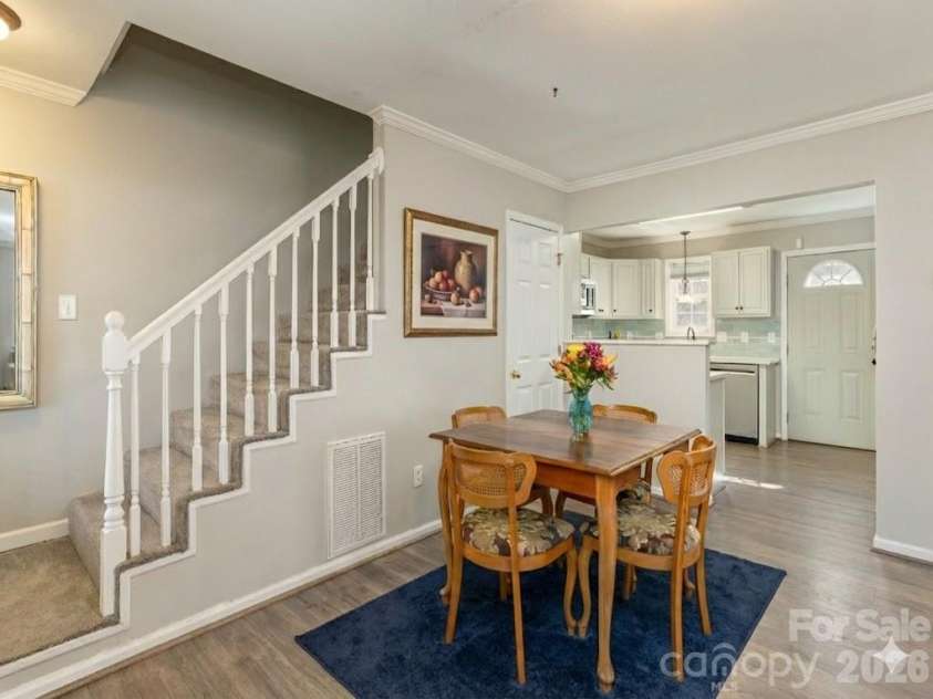 10 Aberdeen Drive, Arden, NC 28704.  MLS# CAR4344820, YatesRealty ID 10276. Virtually staged dining area, stairs lead to primary suites upstairs