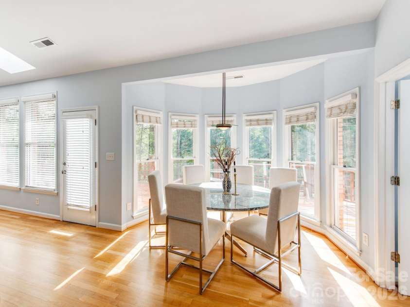 7015 Oakview Lane, Charlotte, NC 28226.  MLS# CAR4365862, YatesRealty ID 10283. Breakfast Area with Matching Custom Made Stone Table and So Many Windows! 