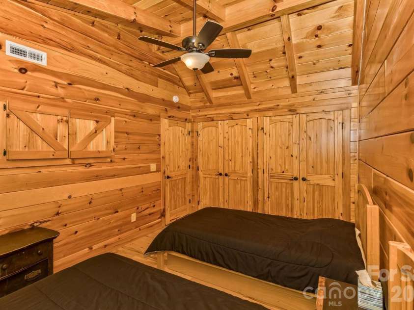 109 Overlook Point Lane, Lake Lure, NC 28746.  MLS# CAR4336925, YatesRealty ID 1029. Bedroom #2 with a vaulted ceiling and a wall of closets