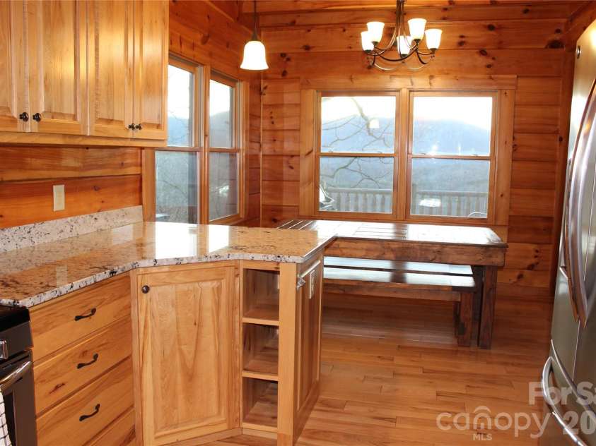 109 Overlook Point Lane, Lake Lure, NC 28746.  MLS# CAR4336925, YatesRealty ID 1029. Kitchen and dining room with mountain and lake views