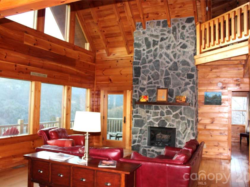 109 Overlook Point Lane, Lake Lure, NC 28746.  MLS# CAR4336925, YatesRealty ID 1029. Living Room with vaulted, beamed ceilings and bug views of the mountains and Lake Lure