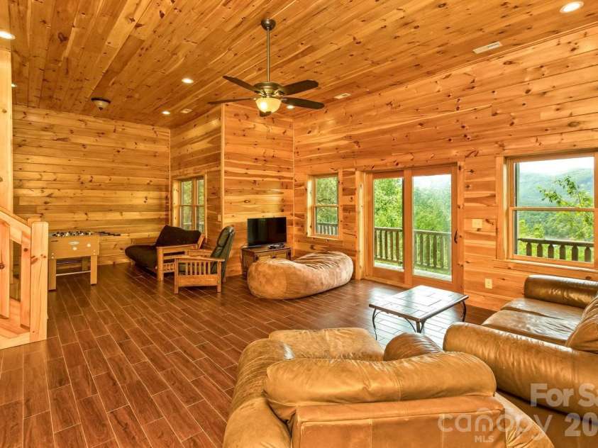 109 Overlook Point Lane, Lake Lure, NC 28746.  MLS# CAR4336925, YatesRealty ID 1029. Lower-level Family Room with high ceilings and views of Lake Lure and the mountains!