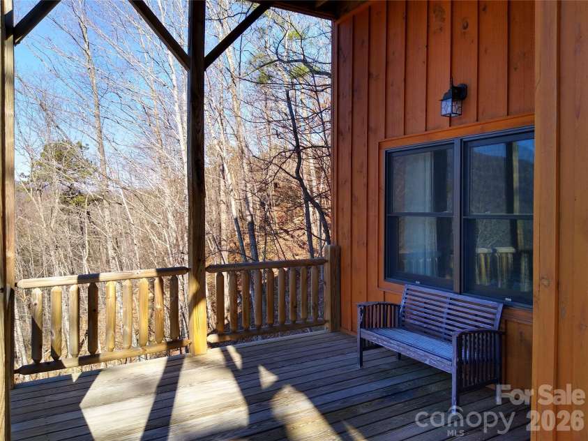 109 Overlook Point Lane, Lake Lure, NC 28746.  MLS# CAR4336925, YatesRealty ID 1029. Lower-level full-length deck with covered porch facing the views