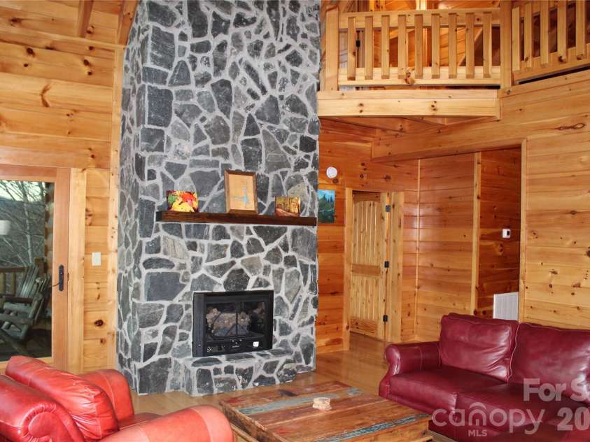 109 Overlook Point Lane, Lake Lure, NC 28746.  MLS# CAR4336925, YatesRealty ID 1029. Stone front fireplace with 