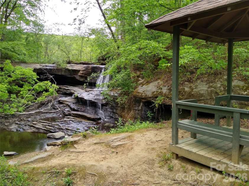 109 Overlook Point Lane, Lake Lure, NC 28746.  MLS# CAR4336925, YatesRealty ID 1029. Waterfall and gazebo at Nature Walk