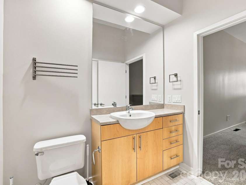 2125 Southend Drive, Charlotte, NC 28203.  MLS# CAR4415556, YatesRealty ID 10291. Bright full bathroom featuring an extended vanity and shower.