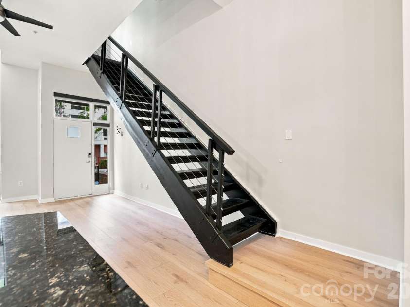 2125 Southend Drive, Charlotte, NC 28203.  MLS# CAR4415556, YatesRealty ID 10291. From the kitchen, enjoy an open sightline across the main level and the home's dramatic loft-style architecture.