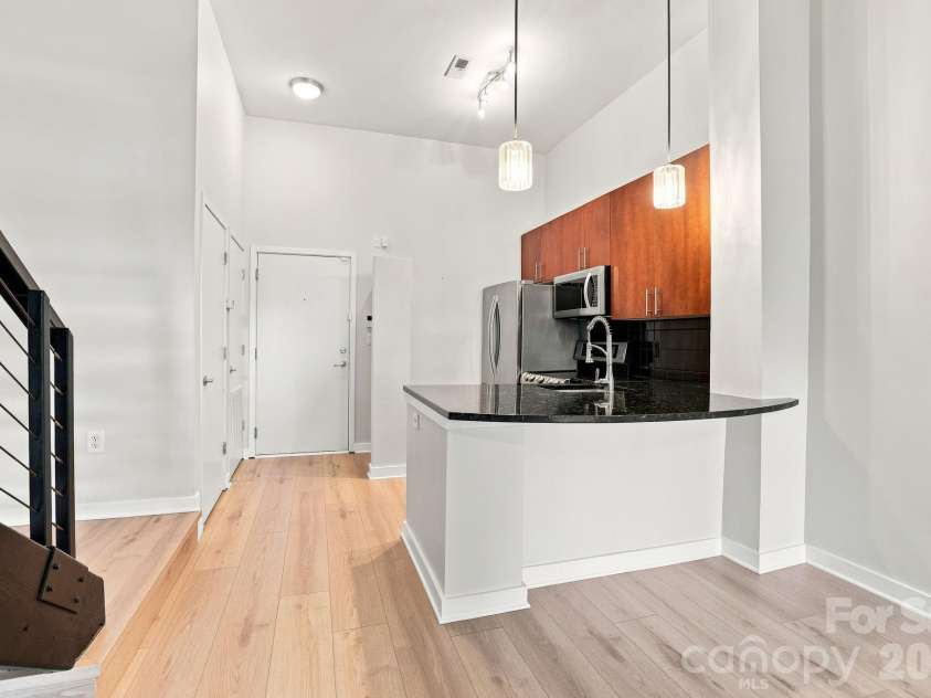 2125 Southend Drive, Charlotte, NC 28203.  MLS# CAR4415556, YatesRealty ID 10291. Open kitchen with breakfast bar flows seamlessly into the main living space—ideal for everyday living and entertaining.