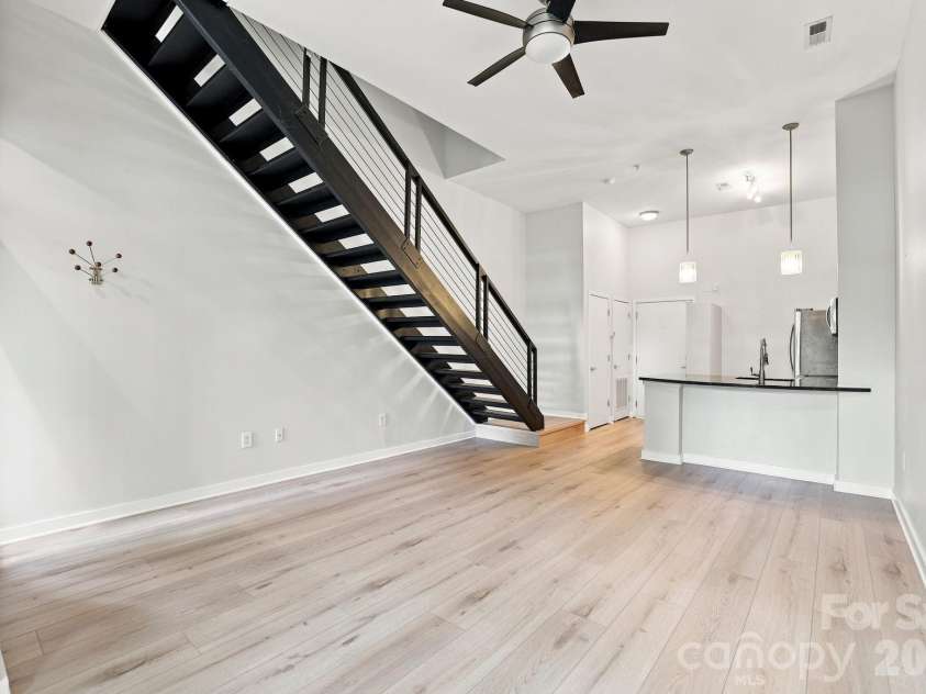 2125 Southend Drive, Charlotte, NC 28203.  MLS# CAR4415556, YatesRealty ID 10291. Open loft architecture connects the living, dining and kitchen areas while the modern staircase adds architectural character.