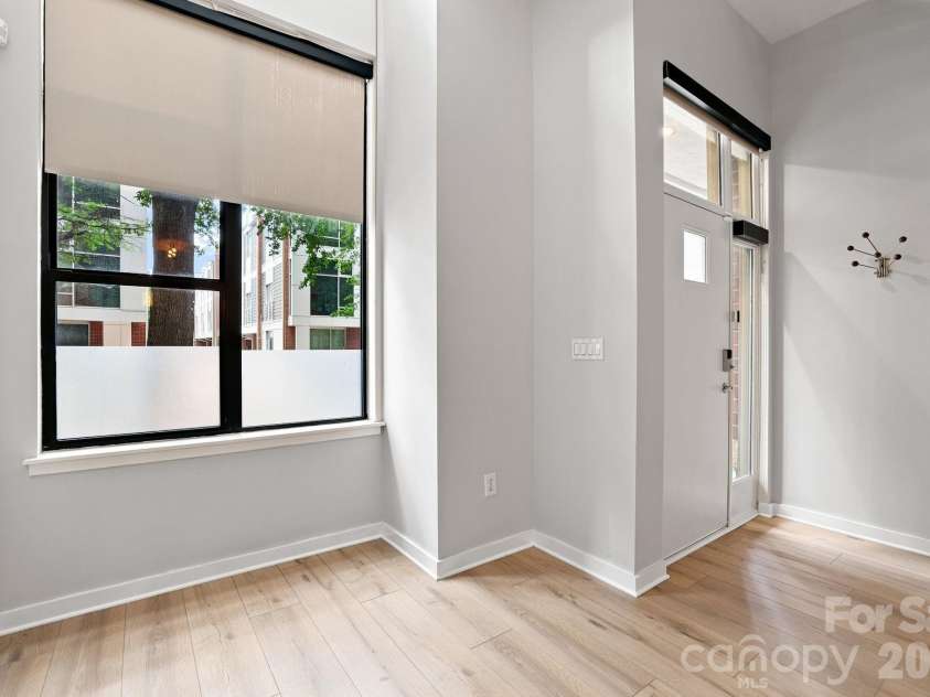 2125 Southend Drive, Charlotte, NC 28203.  MLS# CAR4415556, YatesRealty ID 10291. Oversized windows bring the tree-lined surroundings indoors and highlight this home's unique street-level setting.