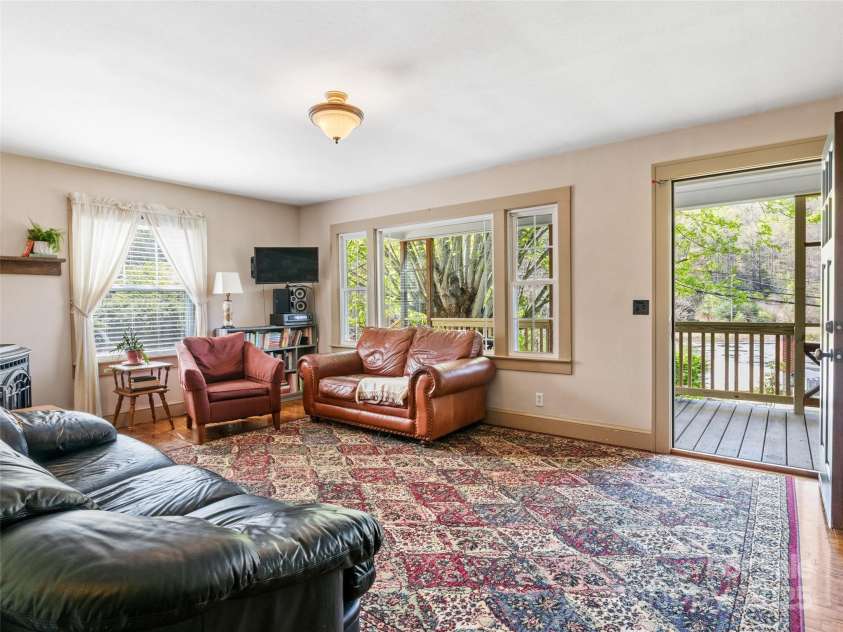 377 Cabin Road, Spruce Pine, NC 28777.  MLS# CAR4256421, YatesRealty ID 103. Living room with view toward porch